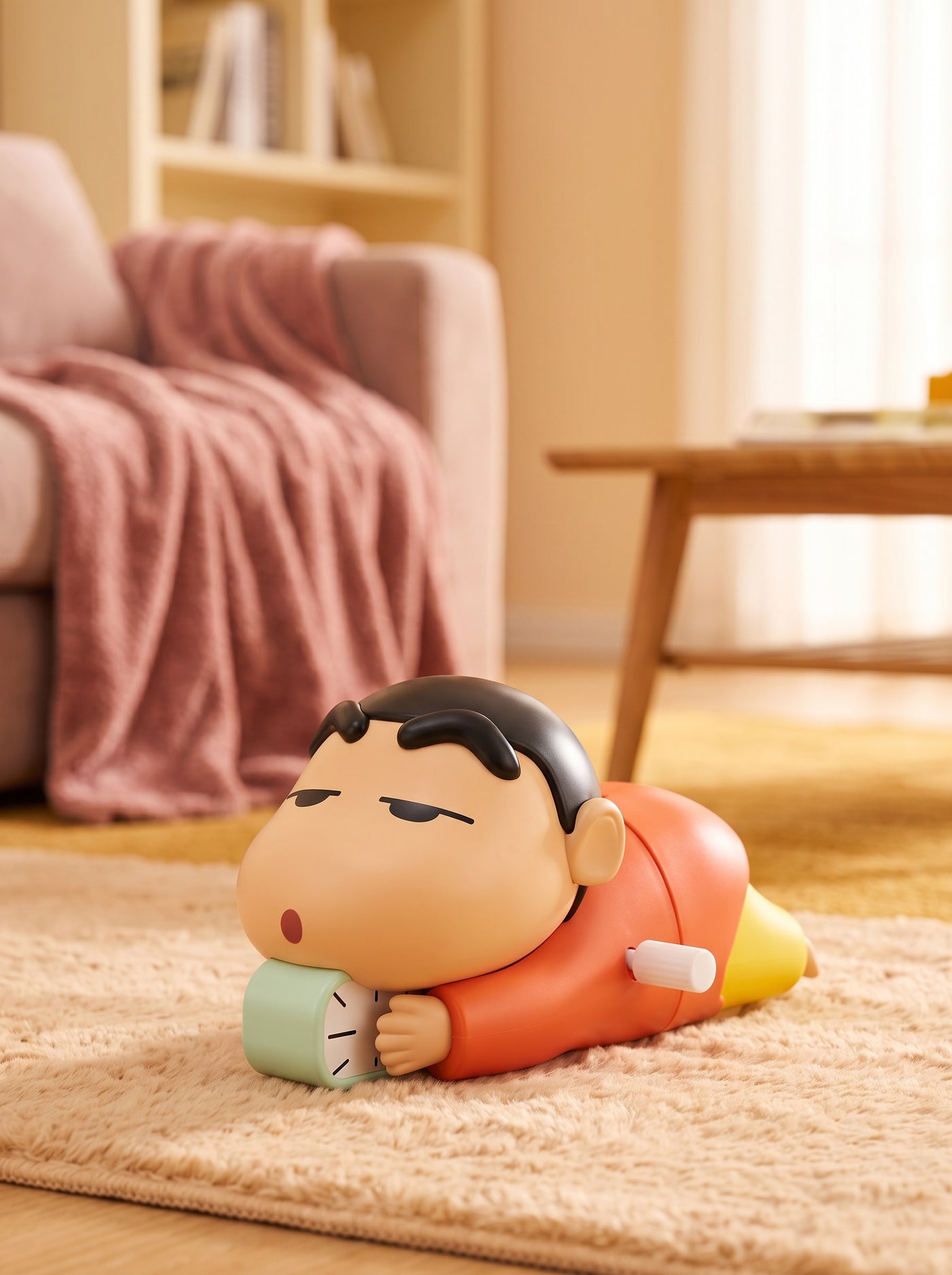Shinchan crawling toy on a textured rug in a warmly lit living room with rose and amber decorative accents.